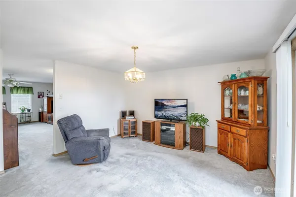 a living room with furniture and a kitchen