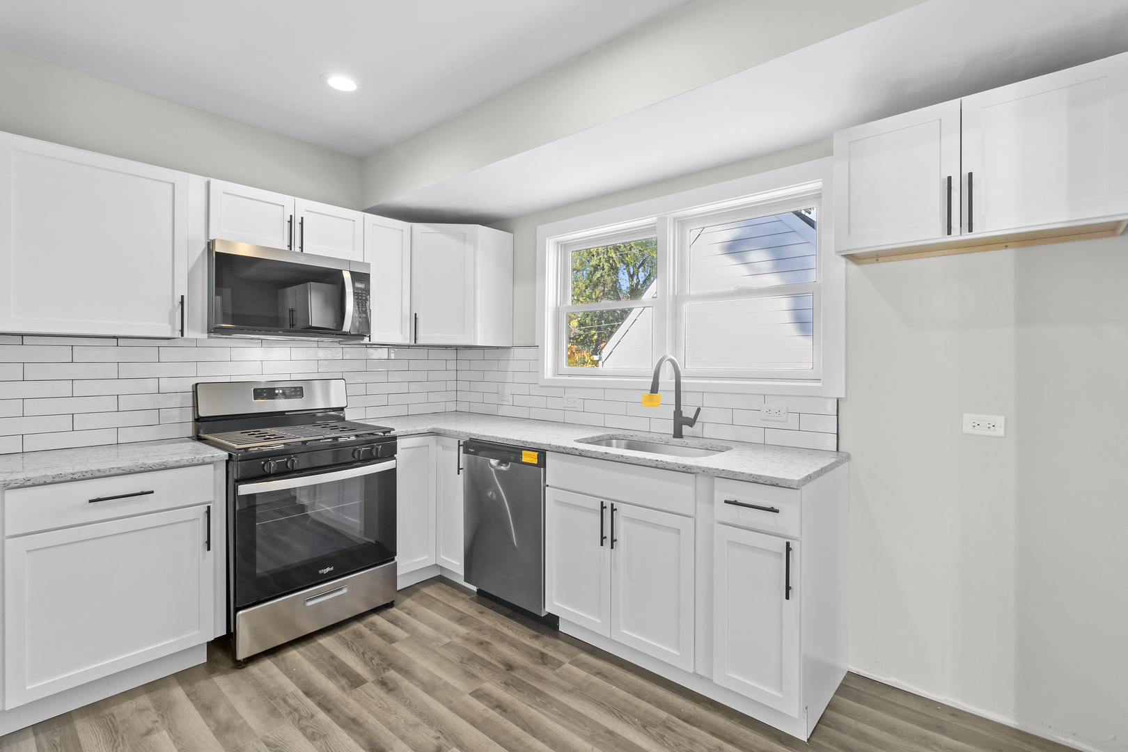 727 Selborne Road Riverside, IL 60546 - Photo 4 of 15 a kitchen with granite countertop a stove a sink and a microwave