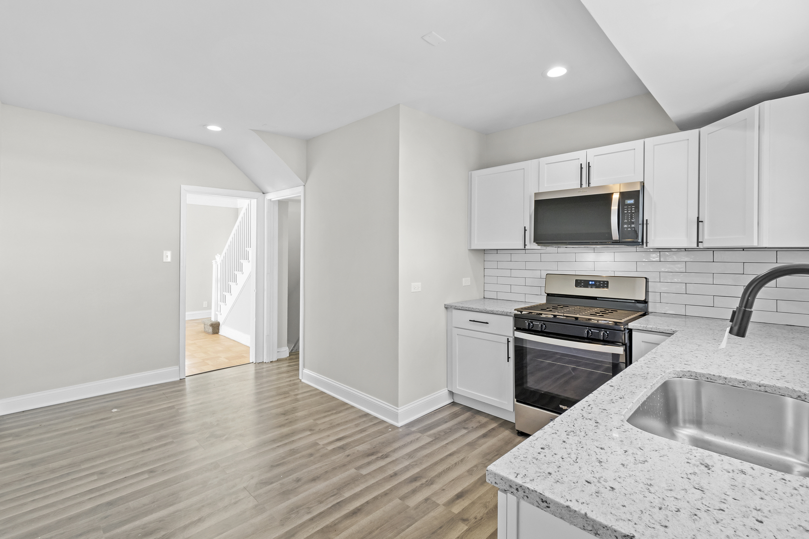 727 Selborne Road Riverside, IL 60546 - Photo 5 of 15 a kitchen with granite countertop a sink wooden floor and stainless steel appliances