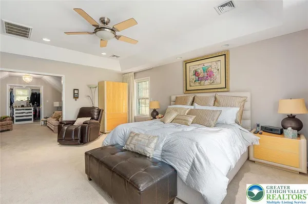 a bedroom with a bed and ceiling fan