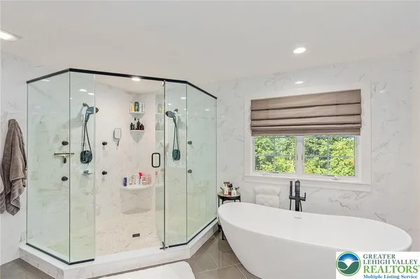 a bath tub sitting next to a shower
