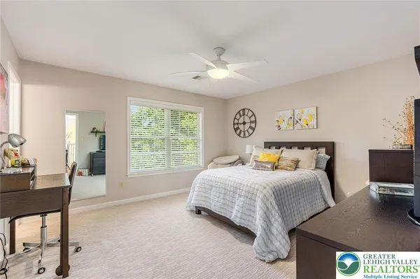 a bedroom with a bed and a desk