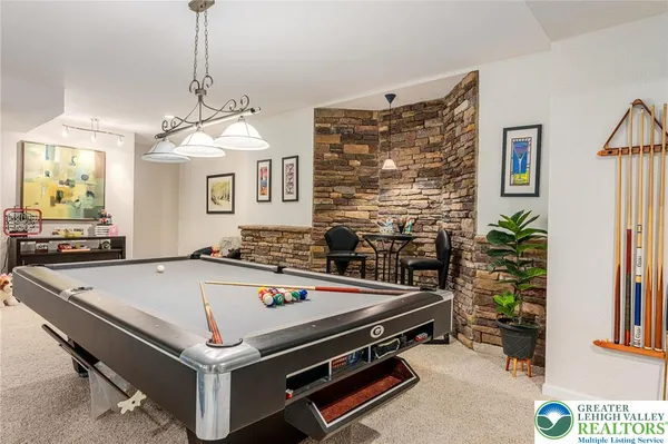 a room with pool table and windows