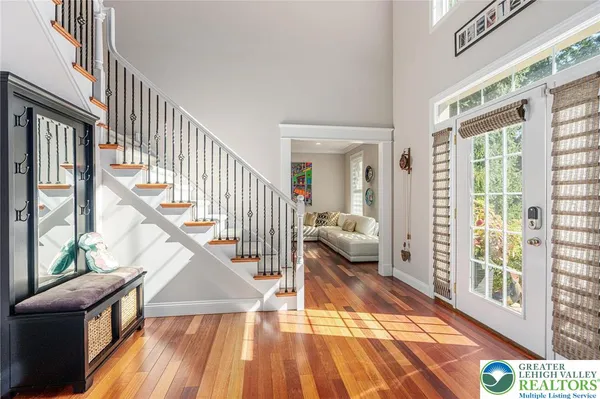 a view of staircase with wooden floor and a rug
