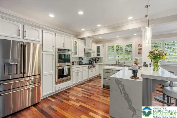 a kitchen with stainless steel appliances a refrigerator sink and microwave