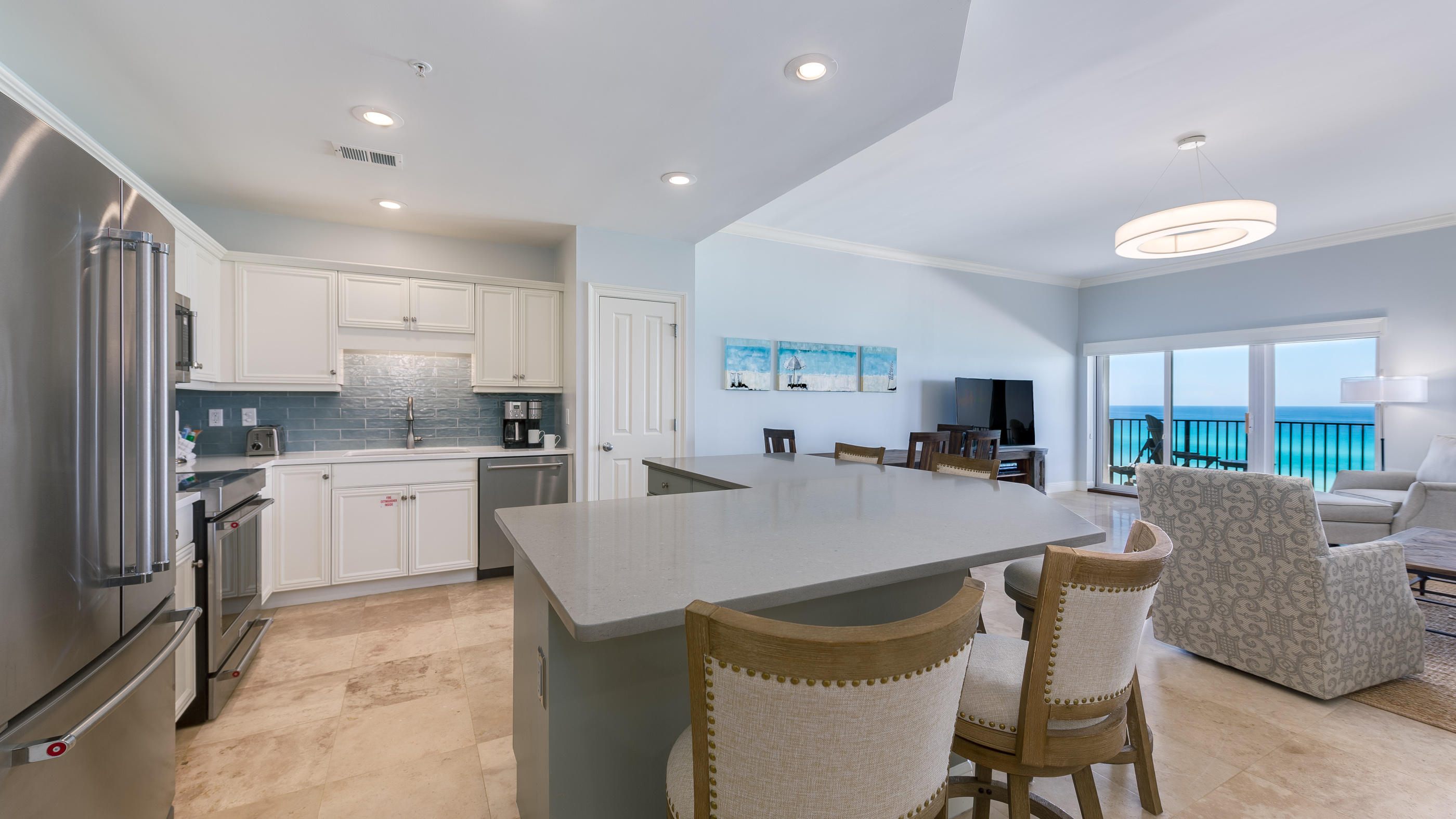 3880 East County Highway 30A, Unit 402 Santa Rosa Beach, FL 32459 - Photo 1 of 62 a large kitchen with kitchen island a dining table and chairs