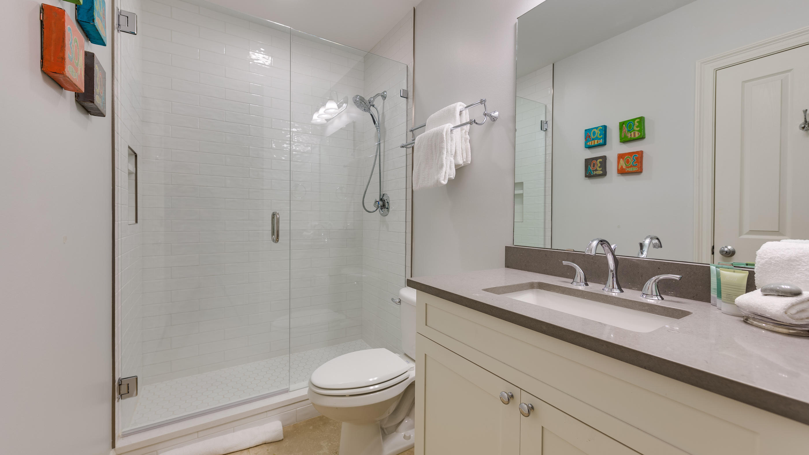 3880 East County Highway 30A, Unit 402 Santa Rosa Beach, FL 32459 - Photo 21 of 62 a bathroom with a granite countertop sink a toilet a large mirror and shower
