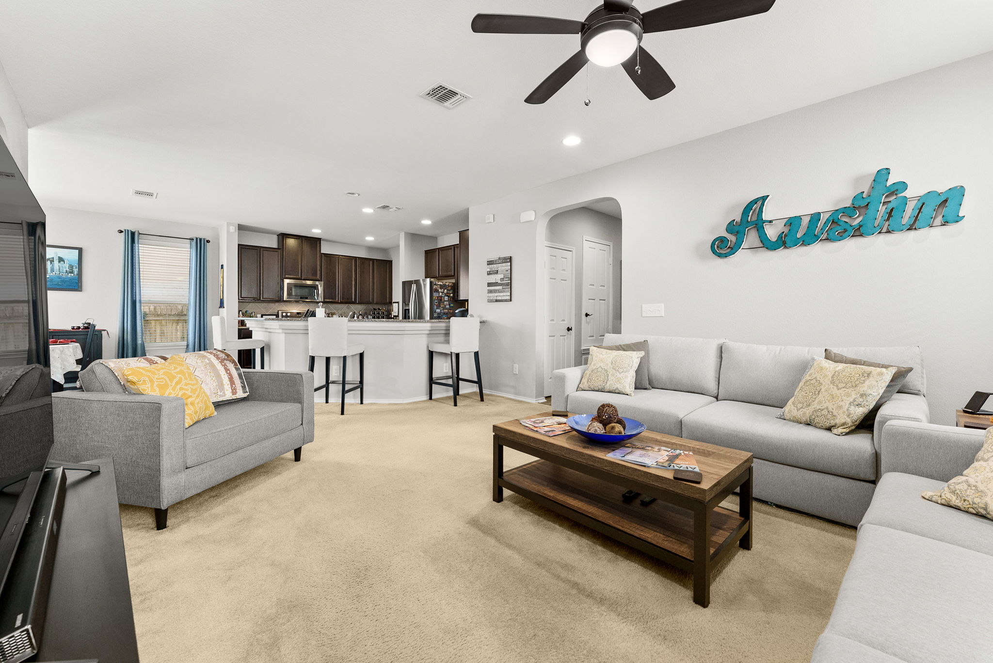 11209 Kildoon Drive Austin, TX 78754 - Photo 36 of 37 Living room with recessed lighting, a ceiling fan, open floor plan to kitchen and dining area.