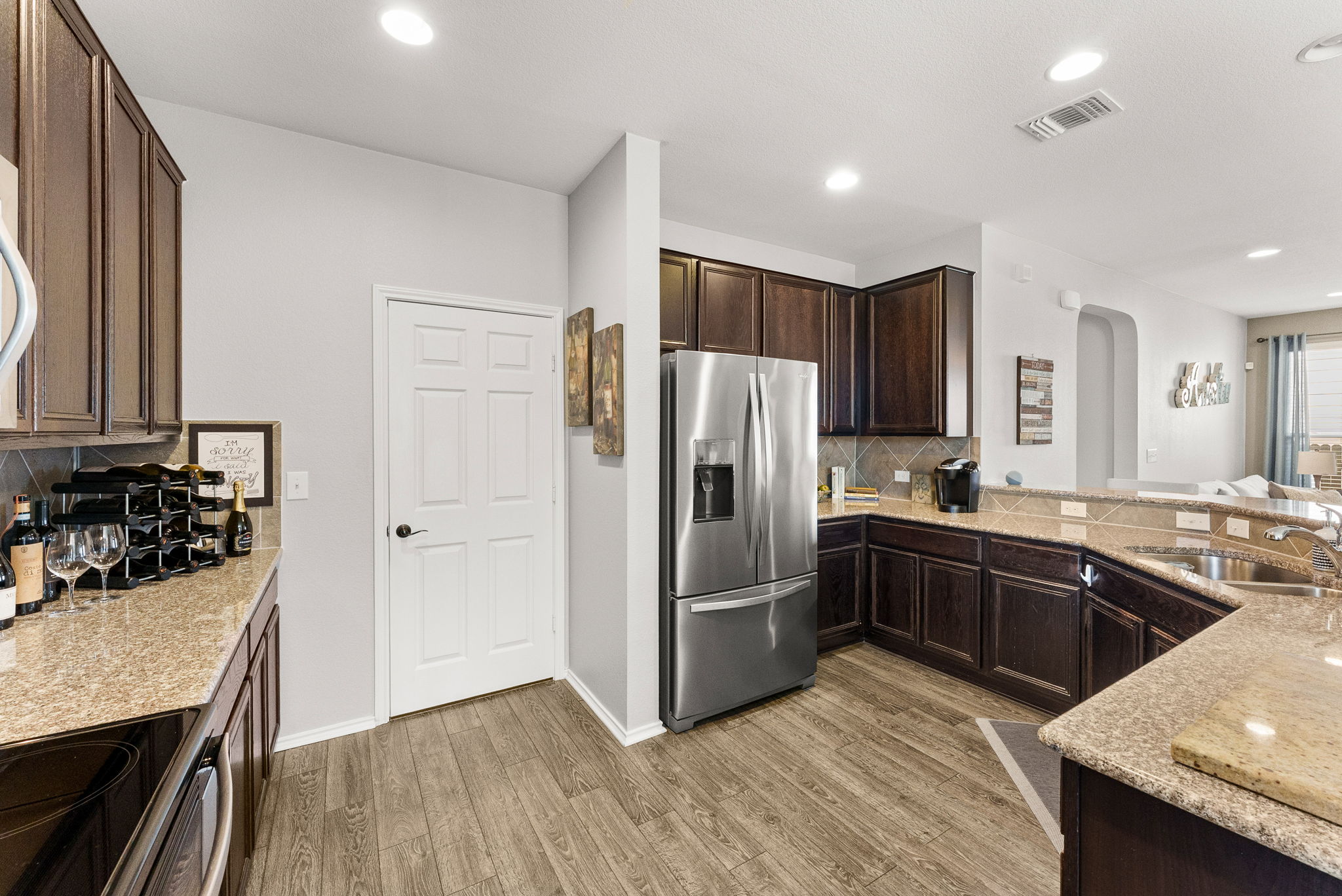 11209 Kildoon Drive Austin, TX 78754 - Photo 15 of 37 Kitchen with dark wood finish cabinets, stainless steel appliances, granite countertops