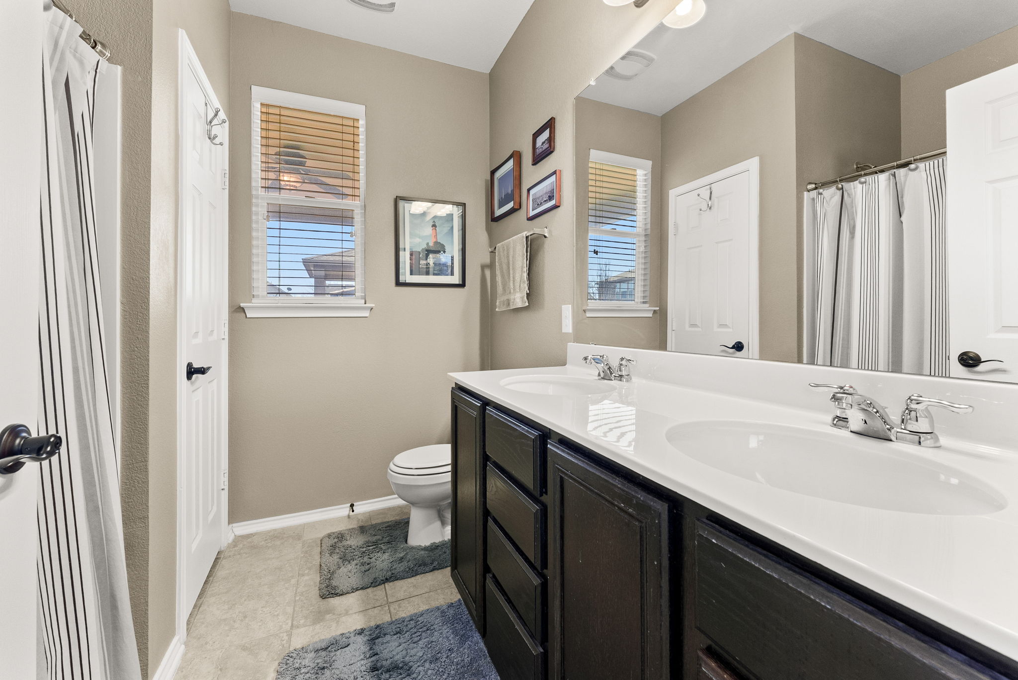 11209 Kildoon Drive Austin, TX 78754 - Photo 23 of 37 Primary Bathroom , double vanity, tub/shower combo, storage/linen closet.