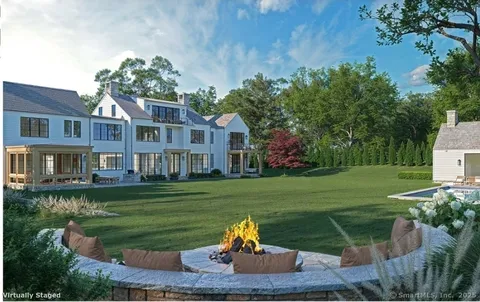 a front view of a house with a yard table and chairs