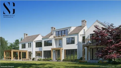 a front view of a building with a garden