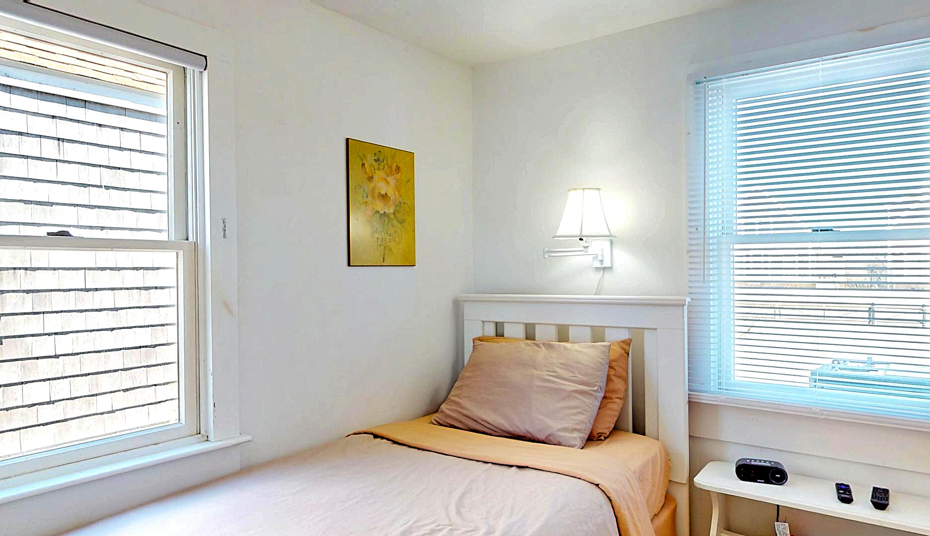 596 Shore Road, Unit G Truro, MA 02666 - Photo 15 of 27 a bedroom with a bed and a window