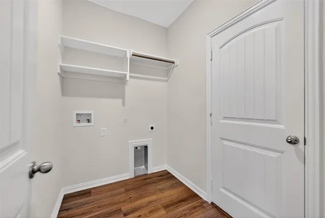 a view of a room with wooden floor