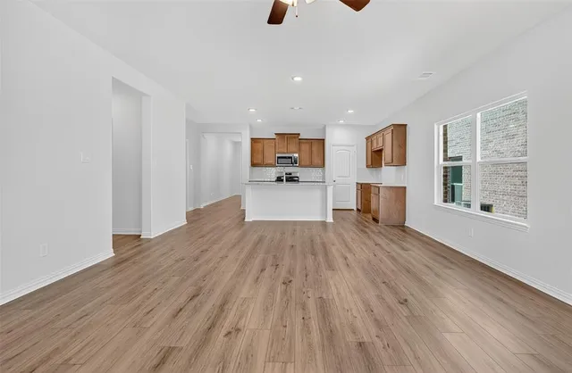 a view of kitchen with wooden floor and electronic appliances