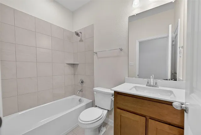 a bathroom with a sink toilet vanity and shower