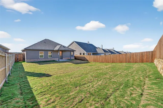 a view of a house with a backyard