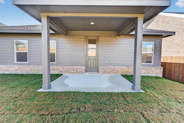 a view of brick house with a yard