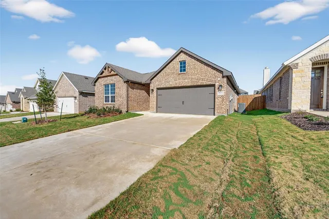 a view of a house with a yard and garage