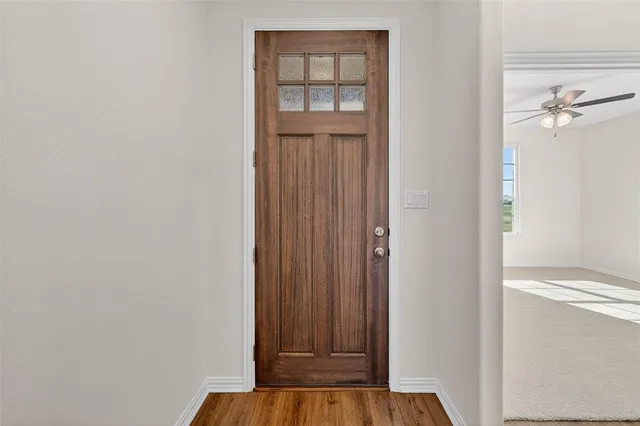 a view of front door with wooden floor