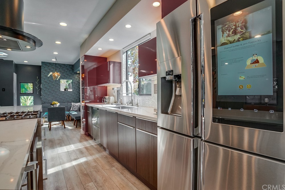 1051 Prospect Avenue Long Beach, CA 90804 - Photo 15 of 56 a kitchen with stainless steel appliances granite countertop a refrigerator and a sink