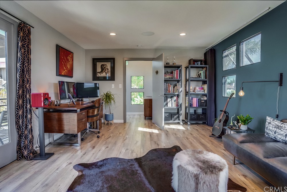 1051 Prospect Avenue Long Beach, CA 90804 - Photo 53 of 56 a living room with furniture a bookshelf and a window
