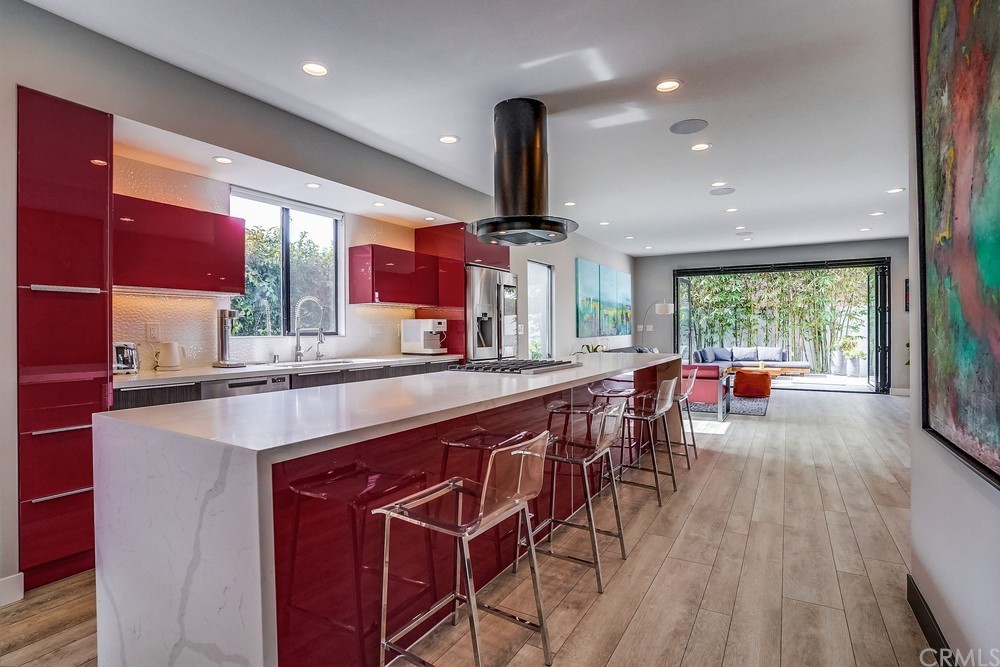 1051 Prospect Avenue Long Beach, CA 90804 - Photo 10 of 56 a kitchen with stainless steel appliances a table and chairs in it