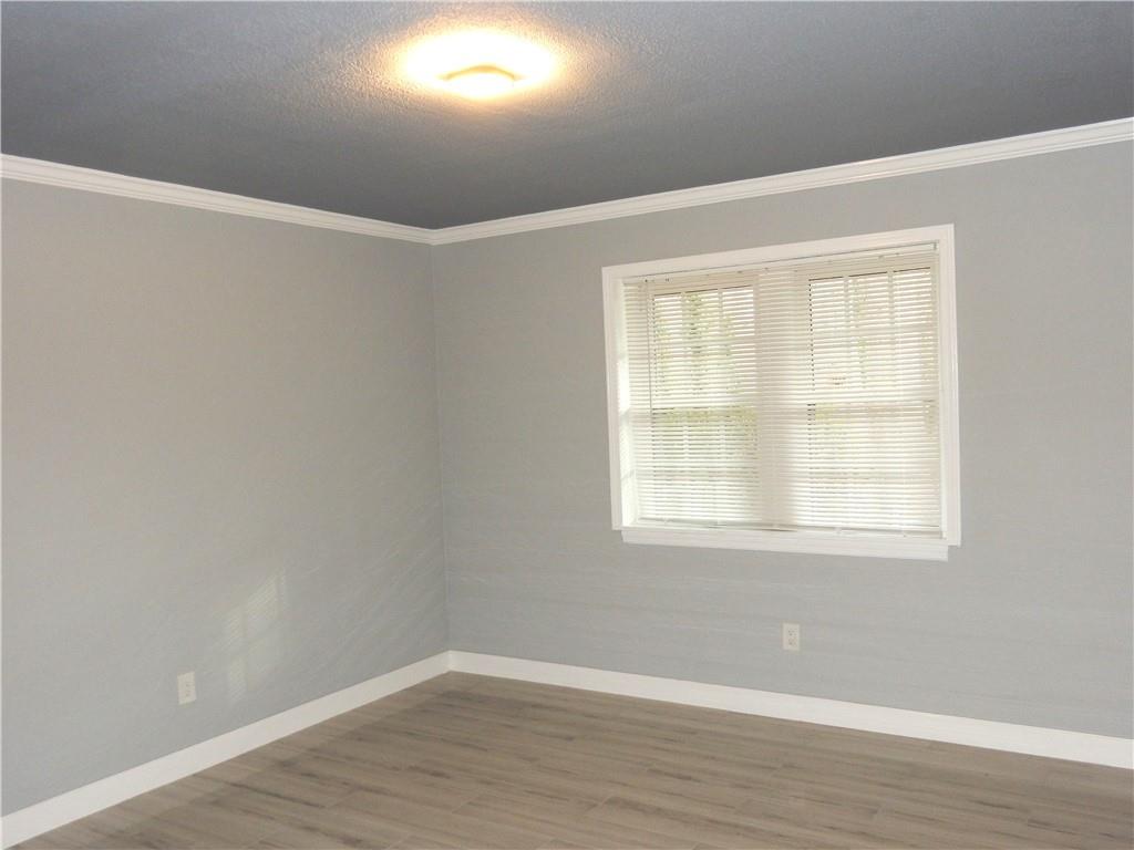 3083 Colonial Way, Unit N Atlanta, GA 30341 - Photo 12 of 20 an empty room with wooden floor and windows