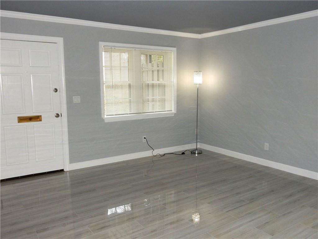 3083 Colonial Way, Unit N Atlanta, GA 30341 - Photo 4 of 20 an empty room with wooden floor and windows