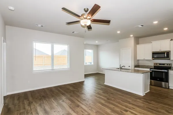a kitchen with stainless steel appliances granite countertop a sink and microwave