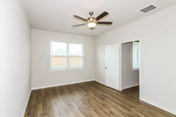 a view of a livingroom with a ceiling fan and wooden floor