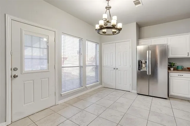 a kitchen with a white cabinets and white appliances