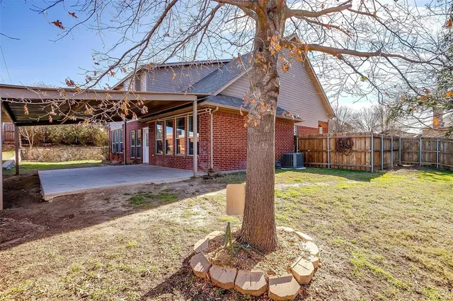 a backyard of a house with table and chairs