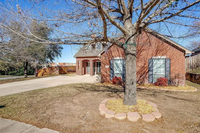 a view of a brick house with entrance gate