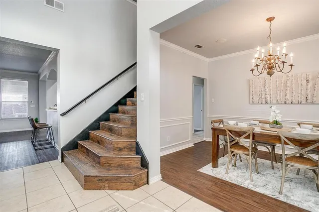 a view of a dining room with furniture wooden floor and chandelier