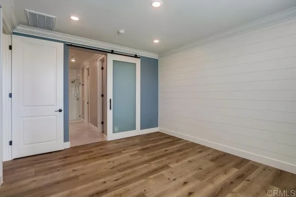 a view of hallway with wooden floor