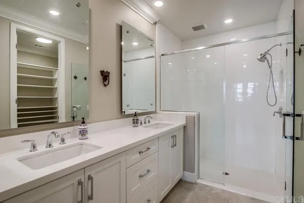 a bathroom with a double vanity sink mirror and double