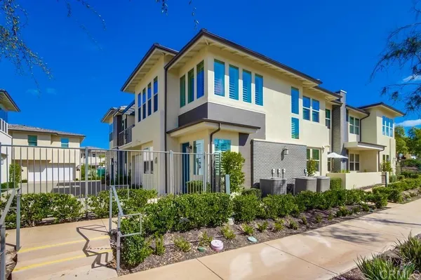 a front view of a multi story residential apartment building with a yard
