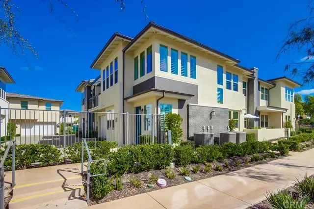 a front view of a multi story residential apartment building with a yard