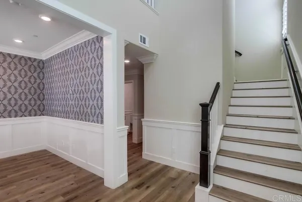 a view of an entryway with wooden floor and staircase
