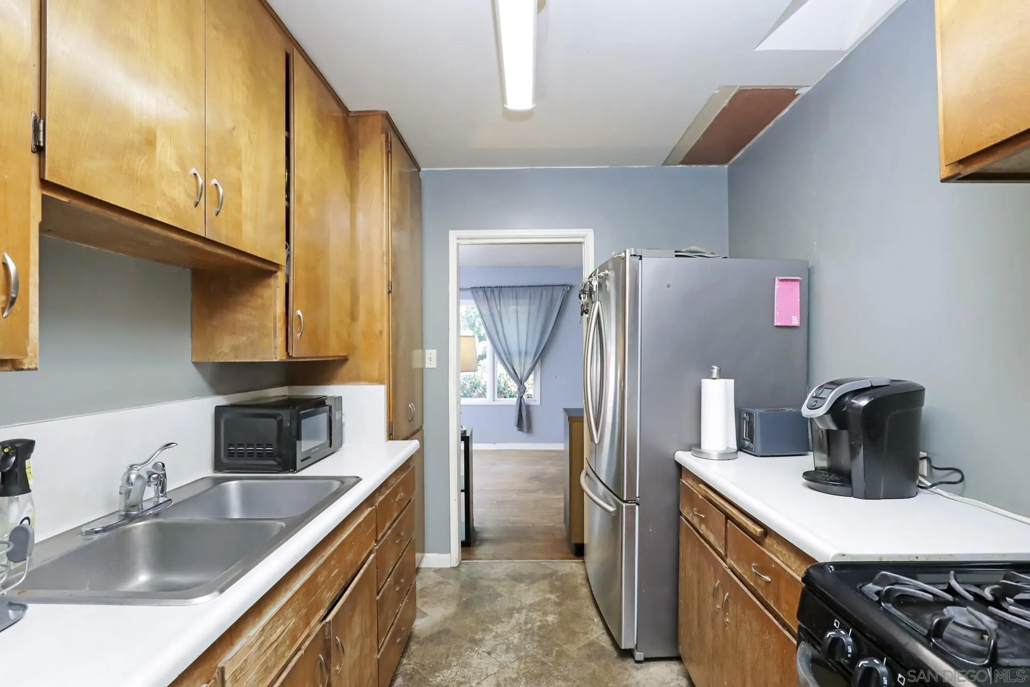 8849 Lamar Street Spring Valley, CA 91977 - Photo 6 of 24 a kitchen with refrigerator and cabinets