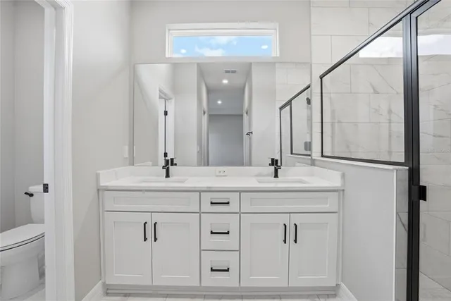 a bathroom with a double vanity sink and a mirror