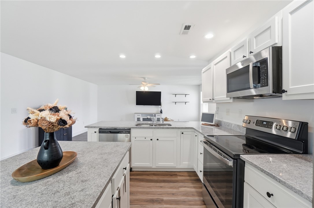 728 East Northern Avenue Springfield, OH 45503 - Photo 11 of 35 This modern kitchen features bright cabinetry, sleek appliances, and durable countertops.