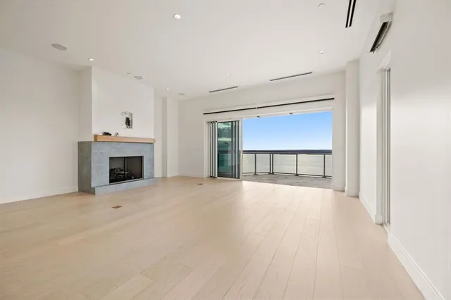 an empty room with a fireplace and window