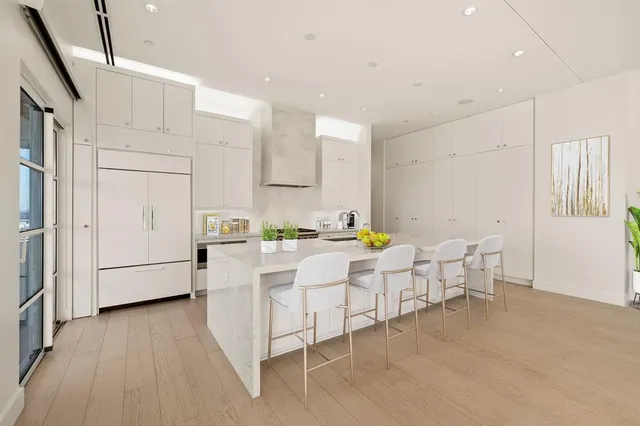 a kitchen with a sink cabinets and wooden floor