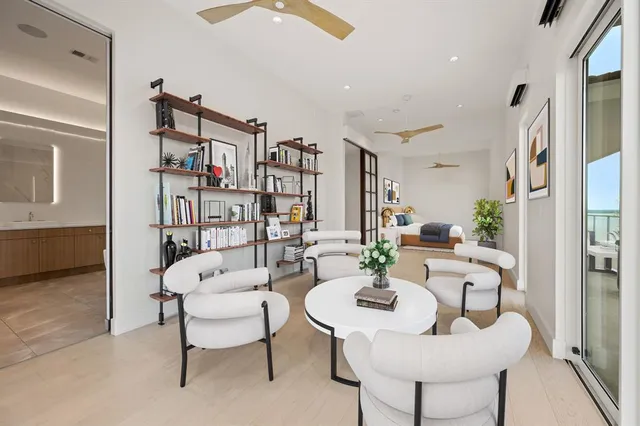 a spacious bedroom with a bed and a dresser