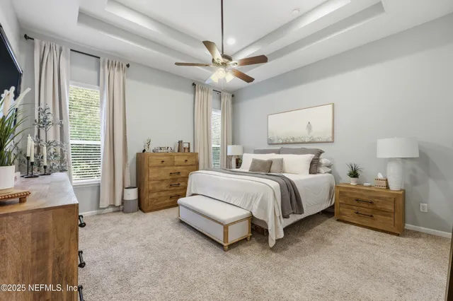 a white bath tub sitting in a bathroom next to a window