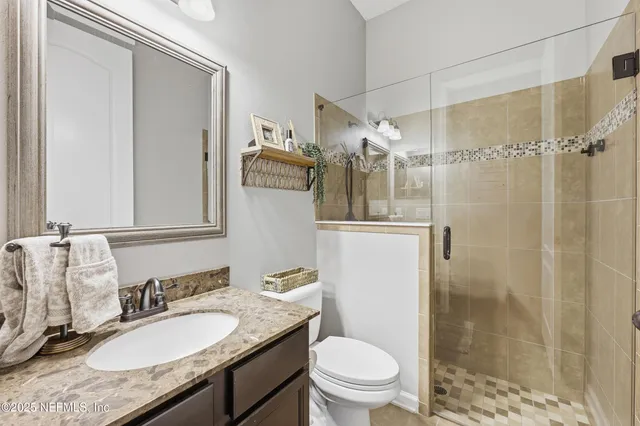 a bedroom with bed and a desk