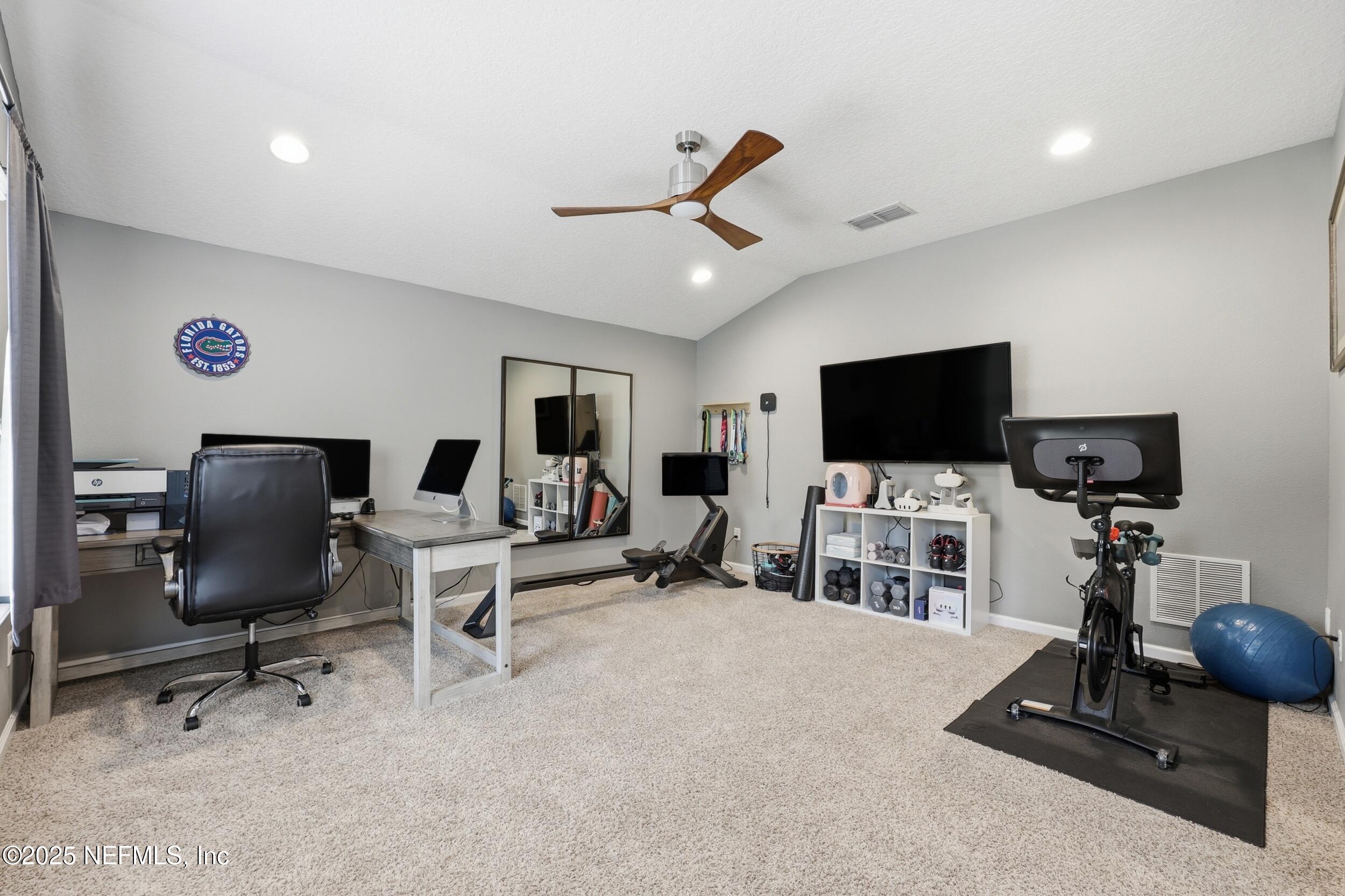 50 Olivette Street St. Johns, FL 32259 - Photo 42 of 74 a view of a livingroom with workspace and a flat screen tv