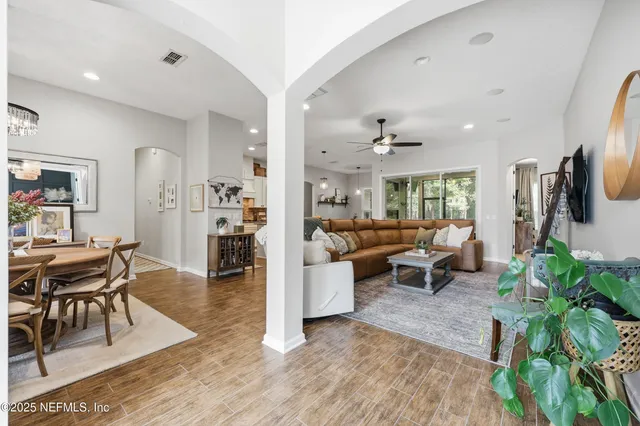 a living room with furniture ceiling fan and a rug